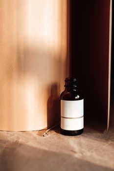Close-up of a minimalist amber glass bottle with a dropper on a neutral background, perfect for product presentations.