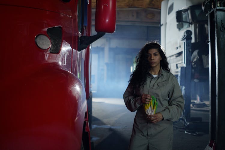 A Woman Wearing Coverall Standing Near The Truck