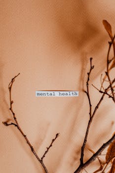 Aesthetic minimalist image featuring branches and 'mental health' text.