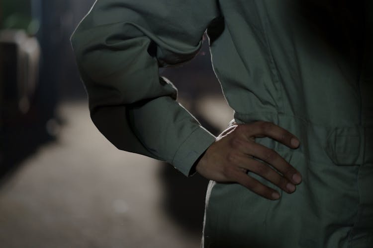 Hand On Waist Of A Person In Boiler Suit