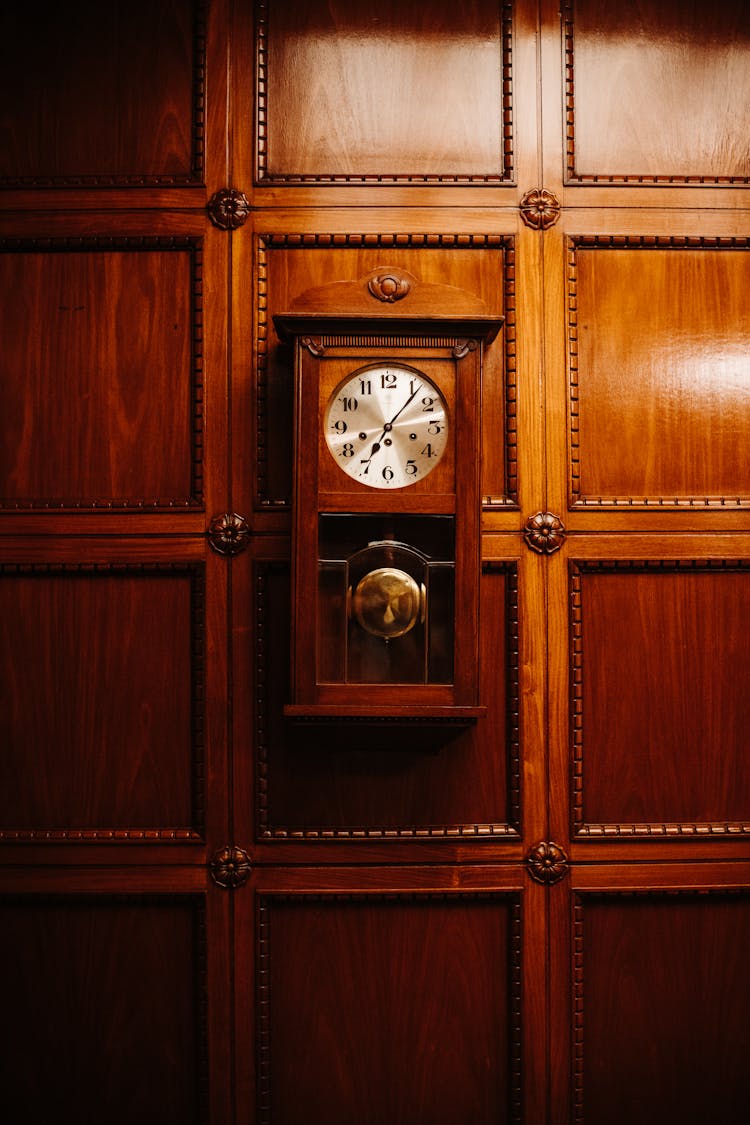 Vintage Clock Hanging On Wooden Wall