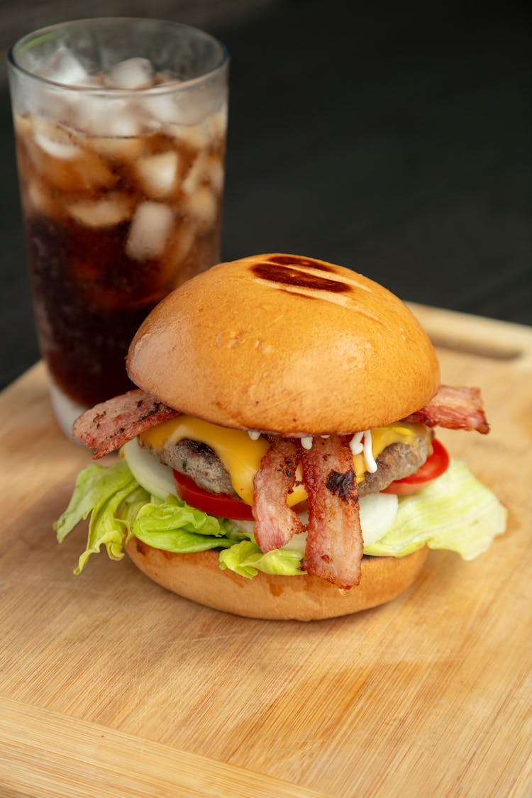 A Delicious Cheeseburger With Bacon, Lettuce And Tomato