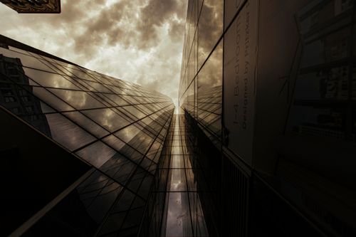 Free Low-angle view of a skyscraper reflecting a dramatic sky in New York City, showcasing modern architecture. Stock Photo
