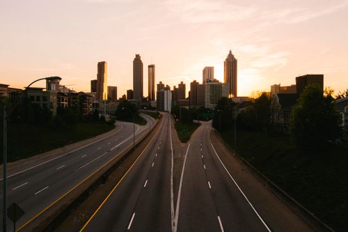 Free Captivating view of Atlanta skyline at sunrise with empty roads in the foreground. Stock Photo