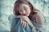 A Woman in Blue Spaghetti Strap Dress Leaning on Her Knees