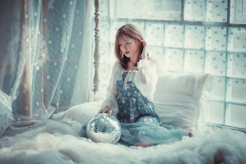 Woman on a Bed with a Disco Ball