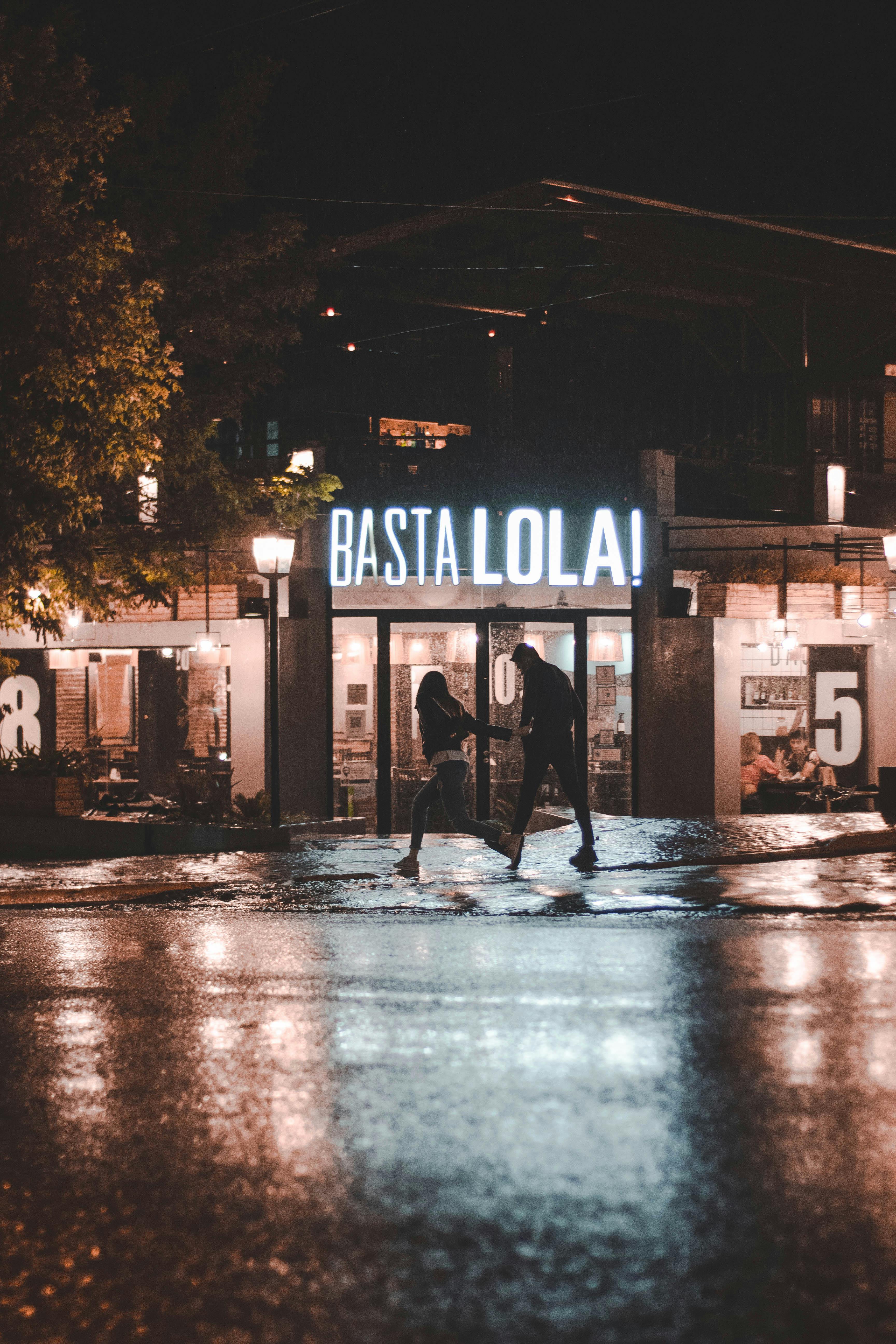 A Couple Walking Near A Restaurant At Night · Free Stock Photo