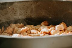 A close-up view of tofu cubes being cooked in a frying pan.