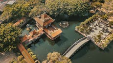 Wooden House and Bridge on Pond in Guangzhou Park, China