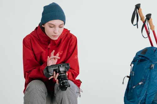 A Woman in Red Jacket Holding Camera