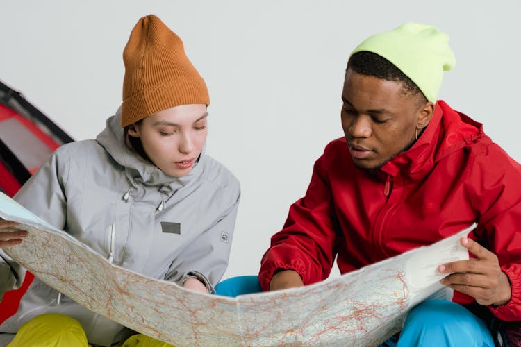 A Man And A Woman Holding A Map