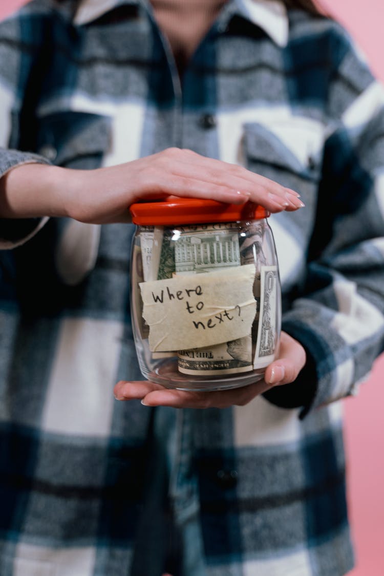 Woman Holding A Glass Jar With Money