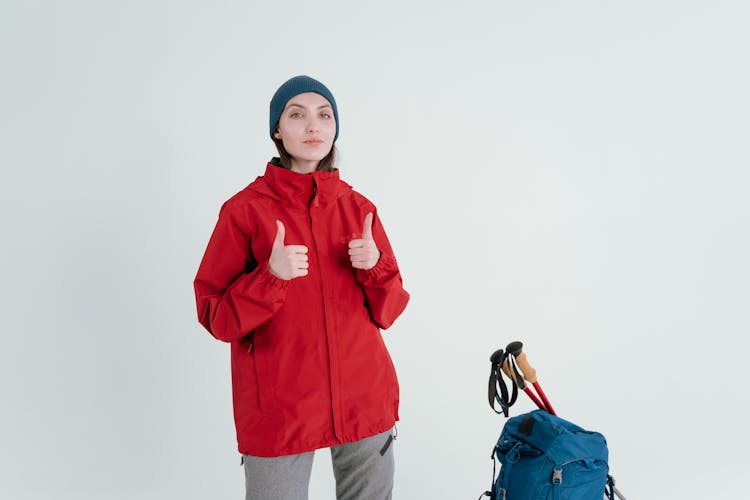 Woman In Red Jacket Doing An Okay Hand Sign 