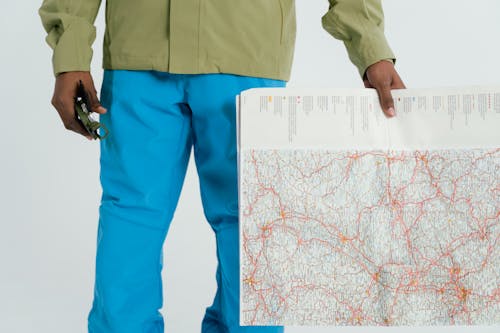 Person Holding A Map and Compass