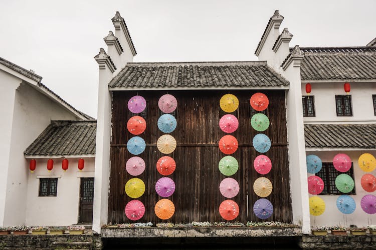 A Wooden Wall Decorated With Colorful Round Ornaments