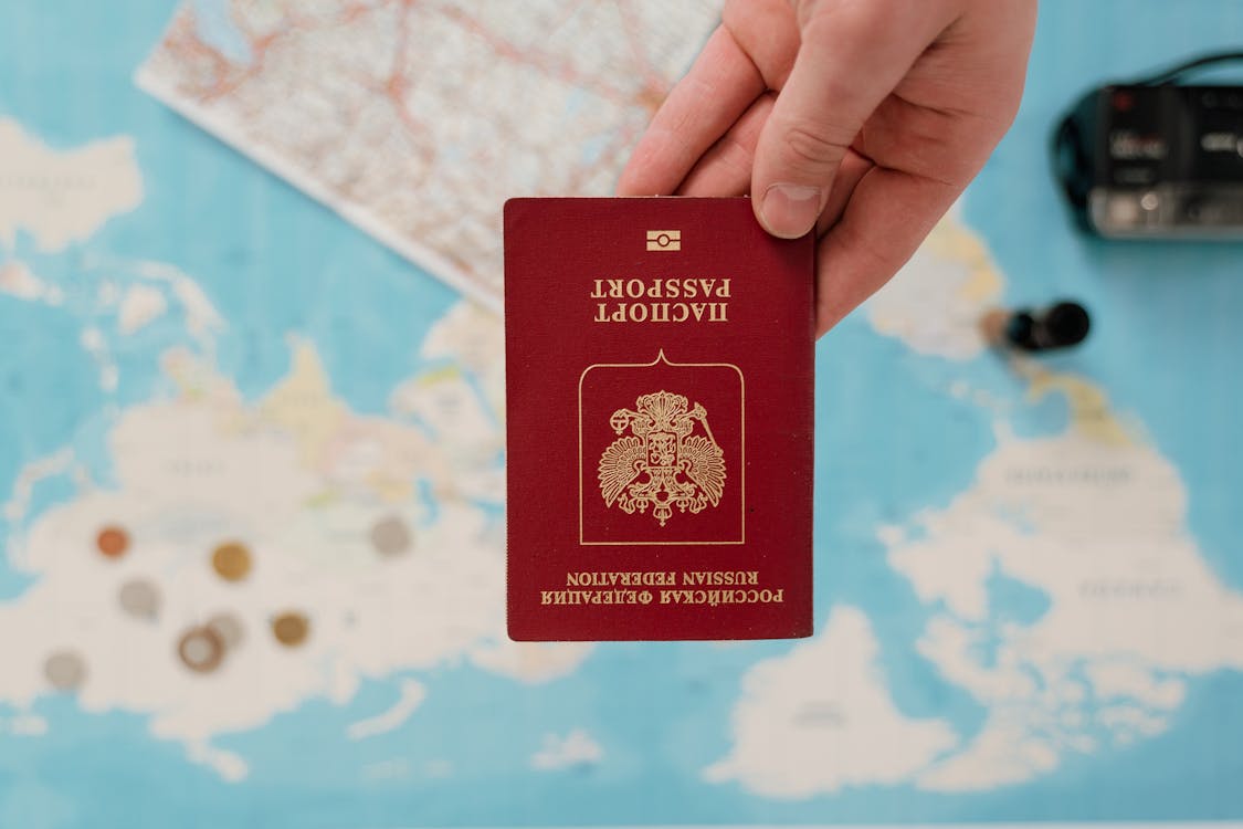 Close-up Photo of a Passport held by a Person 