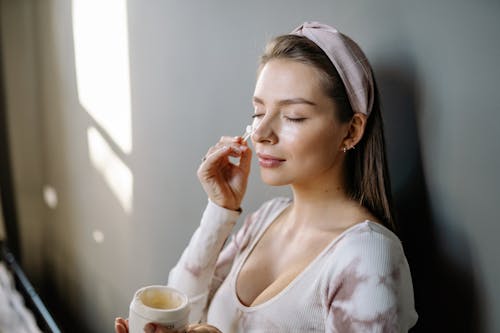Free Woman in White Long Sleeve Shirt Holding White Ceramic Mug Stock Photo