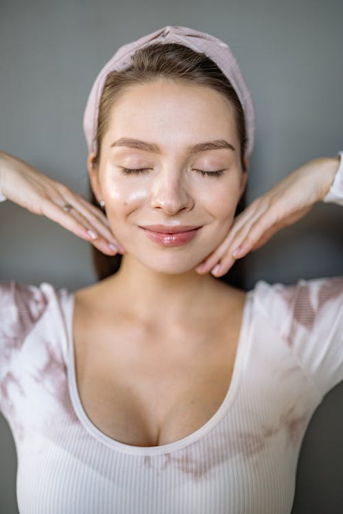 Eyes Closed Smiling Woman with Her Hand on Her Chin