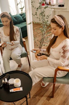 Pregnant woman sitting in a cozy room, pampering herself with skincare products.