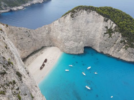 A breathtaking aerial view of Navagio Beach in Zakinthos, Greece, featuring a shipwreck and vibrant blue waters.