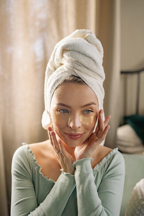 Free A woman with Towel on Her Head and Under Eye Patches Stock Photo