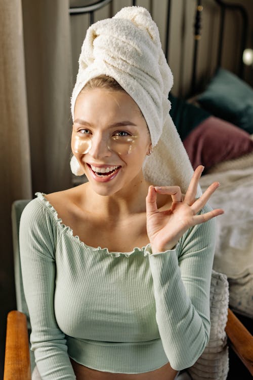 Photo of a Woman with a Head Towel Doing a Okay Hand Sign