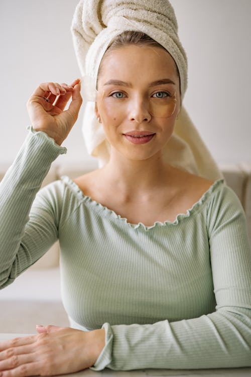 Free Beautiful Woman Removing Under Eye Patches on Her Face Stock Photo