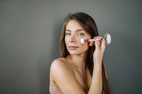 A Woman Using a Jade Roller on Her Faceyoun