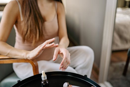Close-up of a woman using skincare products in a relaxed indoor setting.
