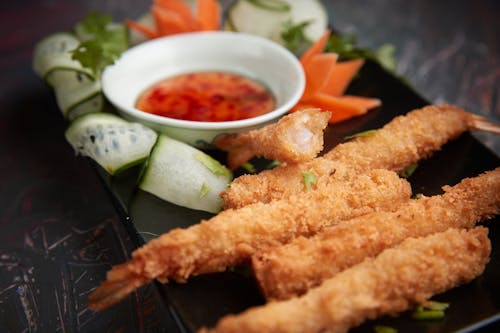 Deep Fried Breaded Shrimps on a Black Plate
