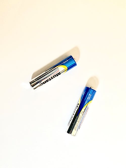 
Flat Lay Photo of Two Batteries on White  Background