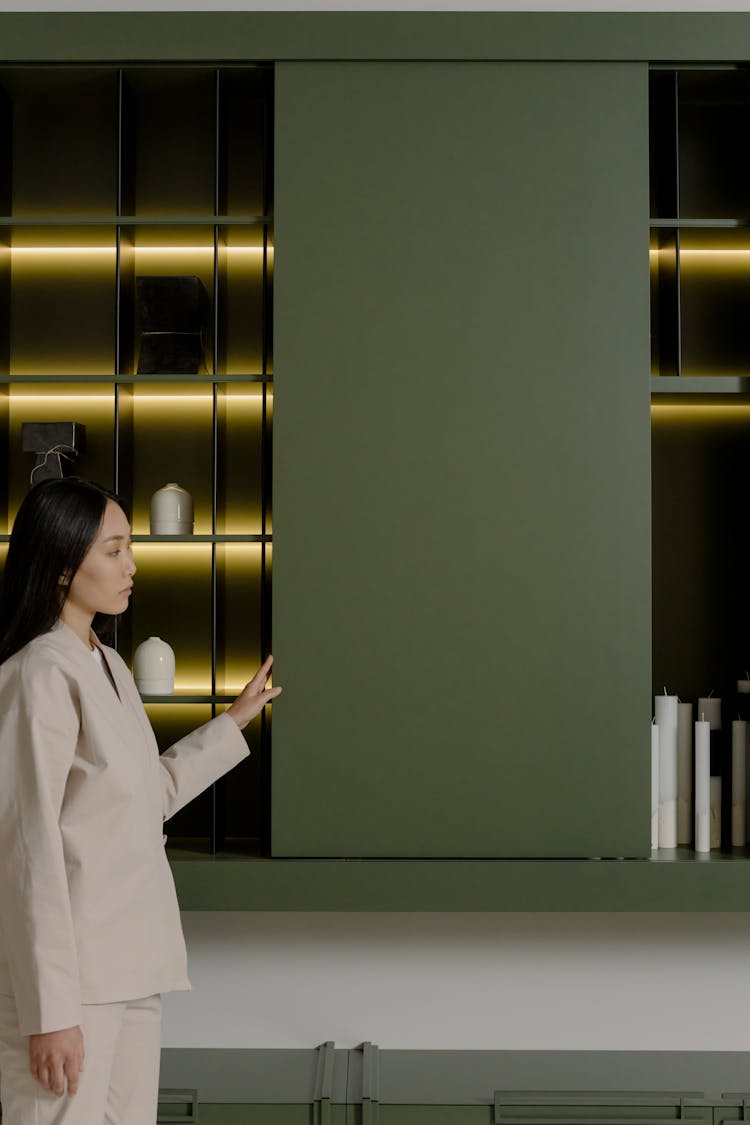 Woman Standing By Wall And Shelves