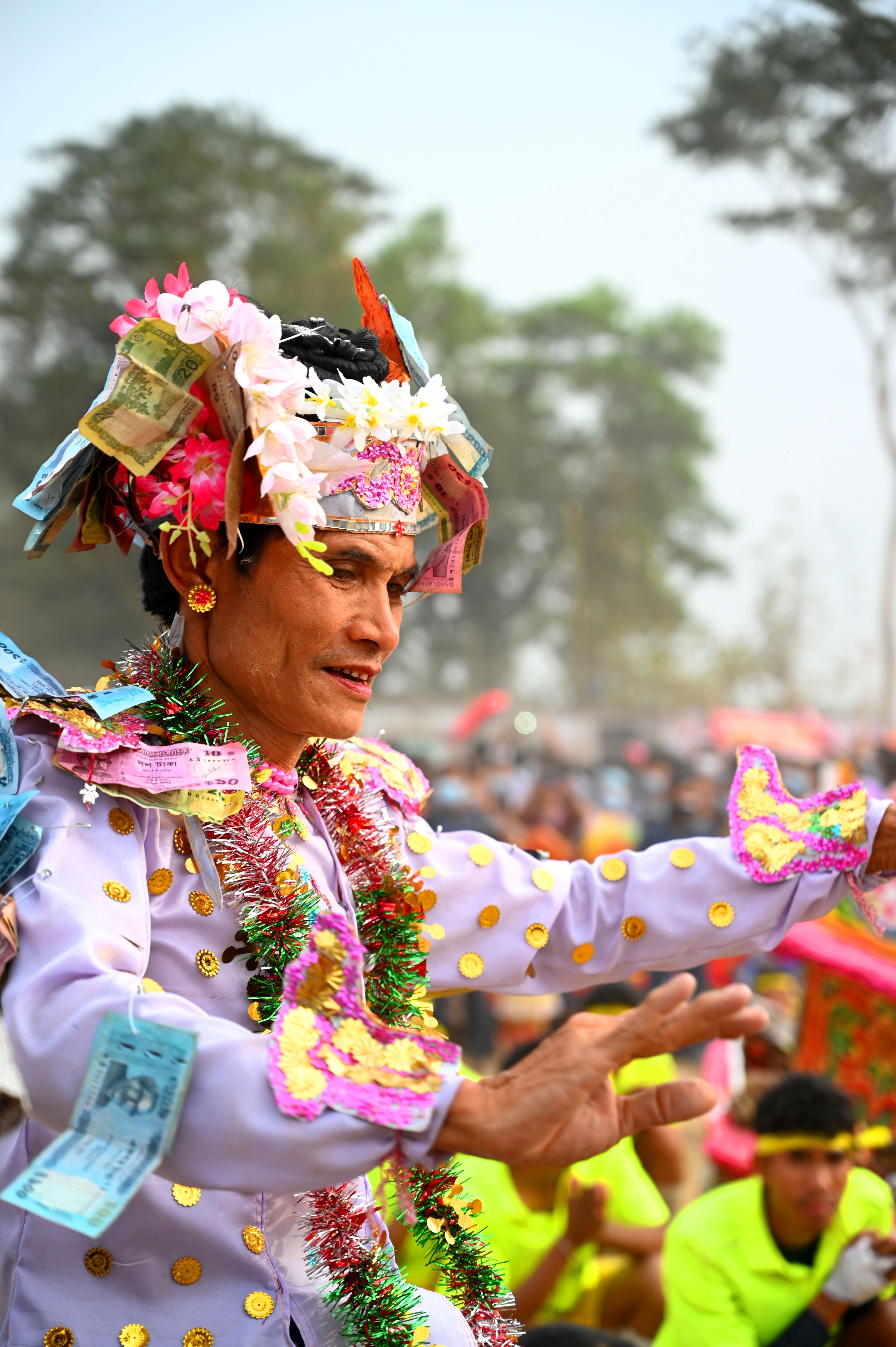 Vibrant cultural festival with traditionally dressed participant in Bangladesh.