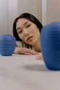 Woman Lying on Blue Exercise Ball
