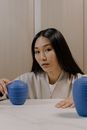 Woman in White Shirt Holding Blue Plastic Container