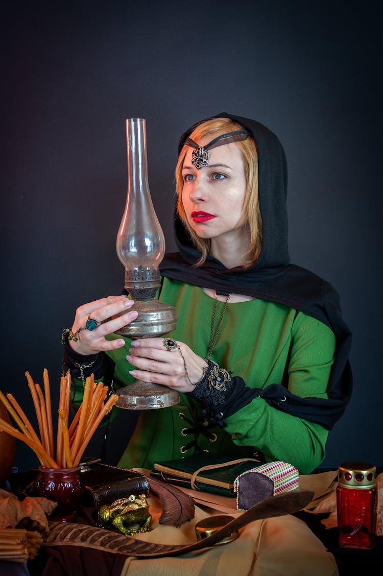 Soothsayer With Old Kerosene Lamp On Dark Background