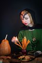 Soothsayer lightning candles while predicting fate on black background