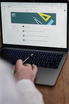 Adult using laptop for online Grade 2 math class, focusing on digital learning tools.