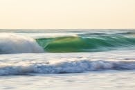 以运动模糊的方式捕捉美丽的海浪，在日落时营造出宁静的海景