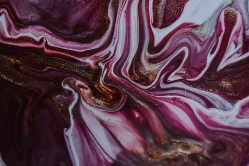 Free Top view of shiny texture of white and purple paints spilled on surface and forming abstract chaotic pattern Stock Photo