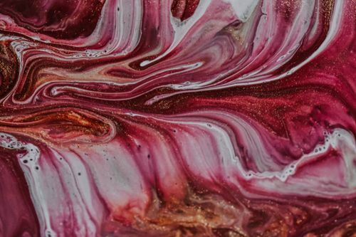 Free Top view of messy pattern of bright colorful paints mixing with each other and creating abstract swirls Stock Photo