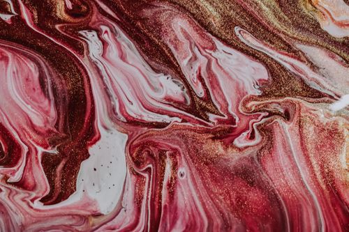 Free Top view of glimmering surface of messy bright colorful inks mixing and forming abstract artwork Stock Photo