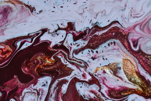 Free From above of abstract background of blended white red and golden paints forming chaotic pattern Stock Photo