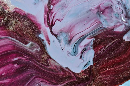 Blended wet white and purple dyes forming abstract painting