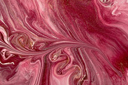 Shiny surface of blended pink dye as abstract background