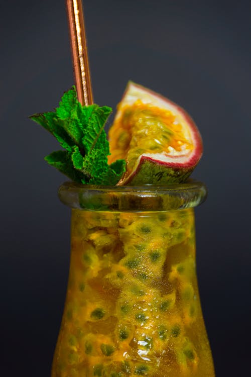 Close-Up Photograph of a Drink with a Slice of Passion Fruit