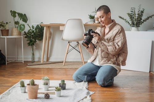 Photo of a Woman Looking at Her Black Camera