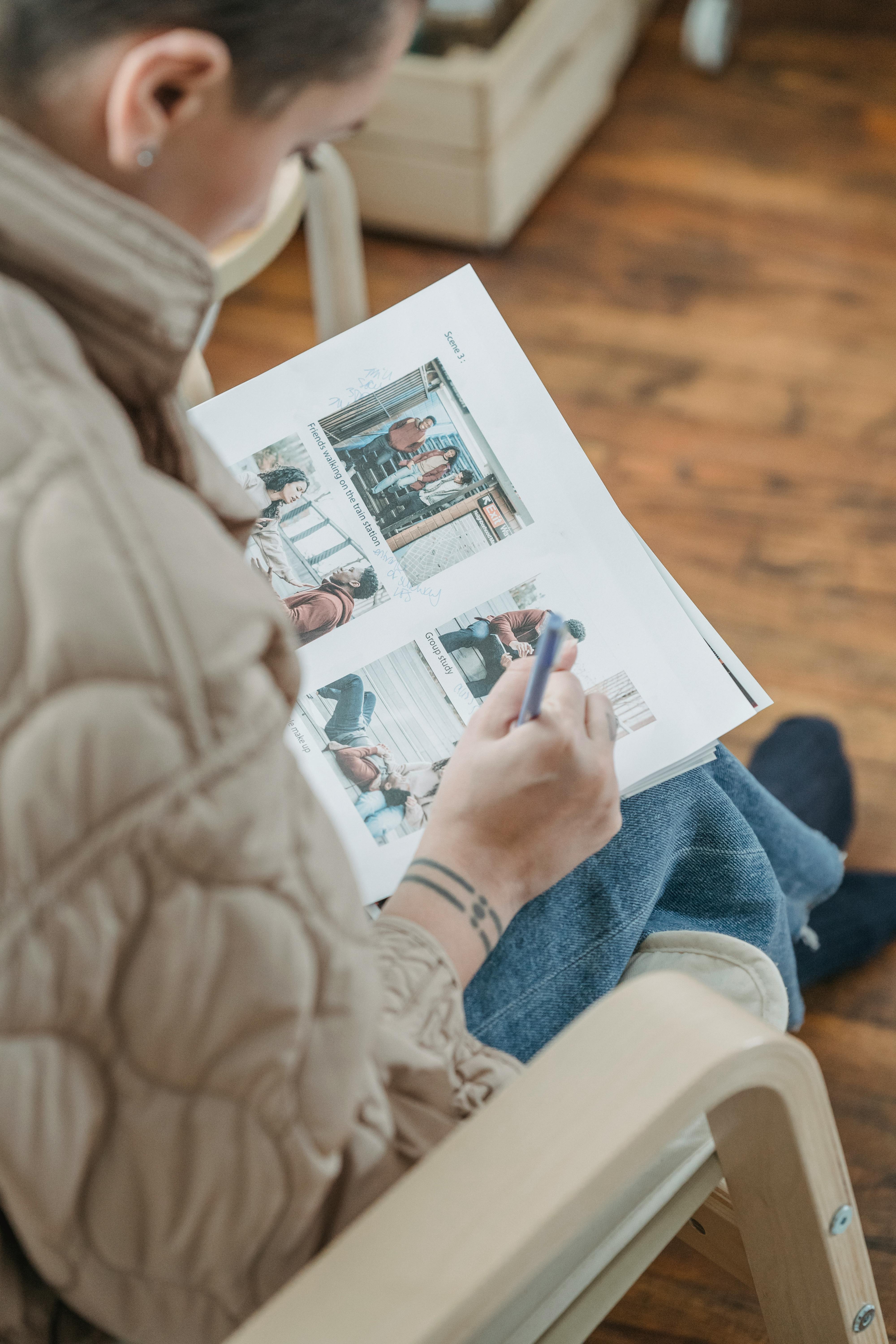 person in blue denim jeans holding white printer paper