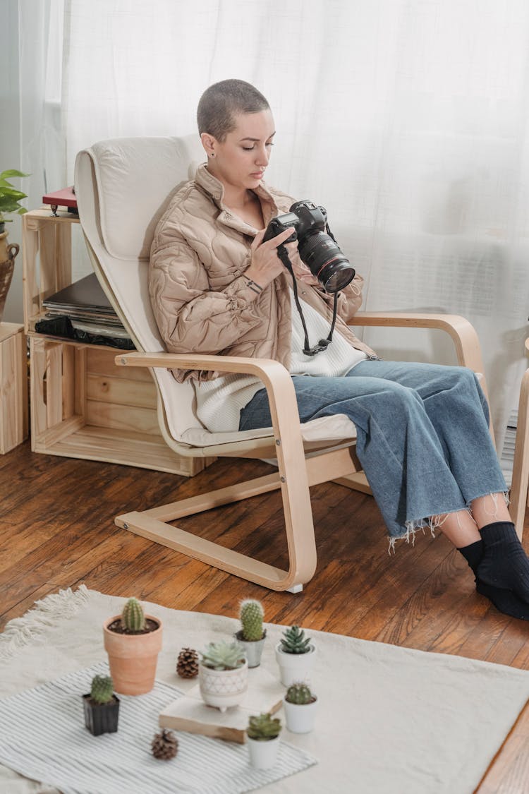 Photo Of A Woman Sitting On A Chair While Looking At Her Camera