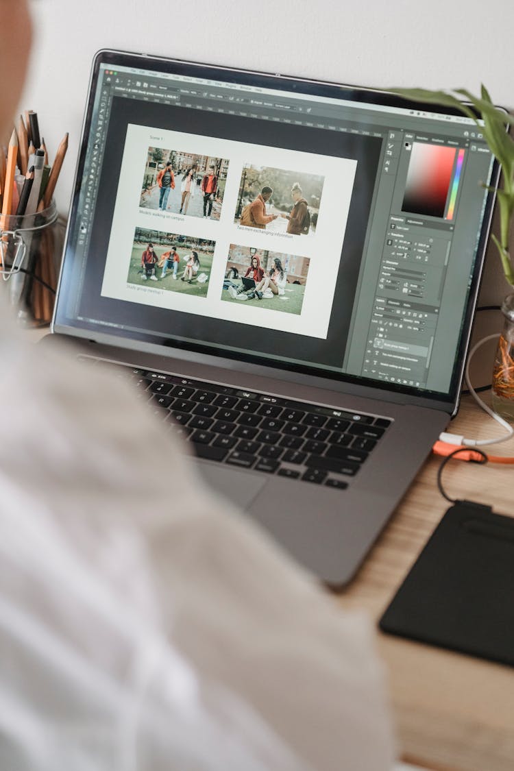 Unrecognizable Person Working On Laptop And Choosing Photos